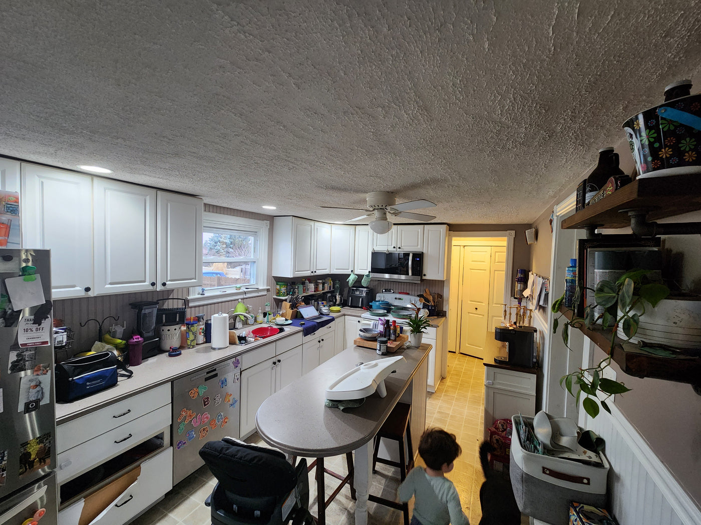 Kitchen with white cabinets, countertops, and a refrigerator.