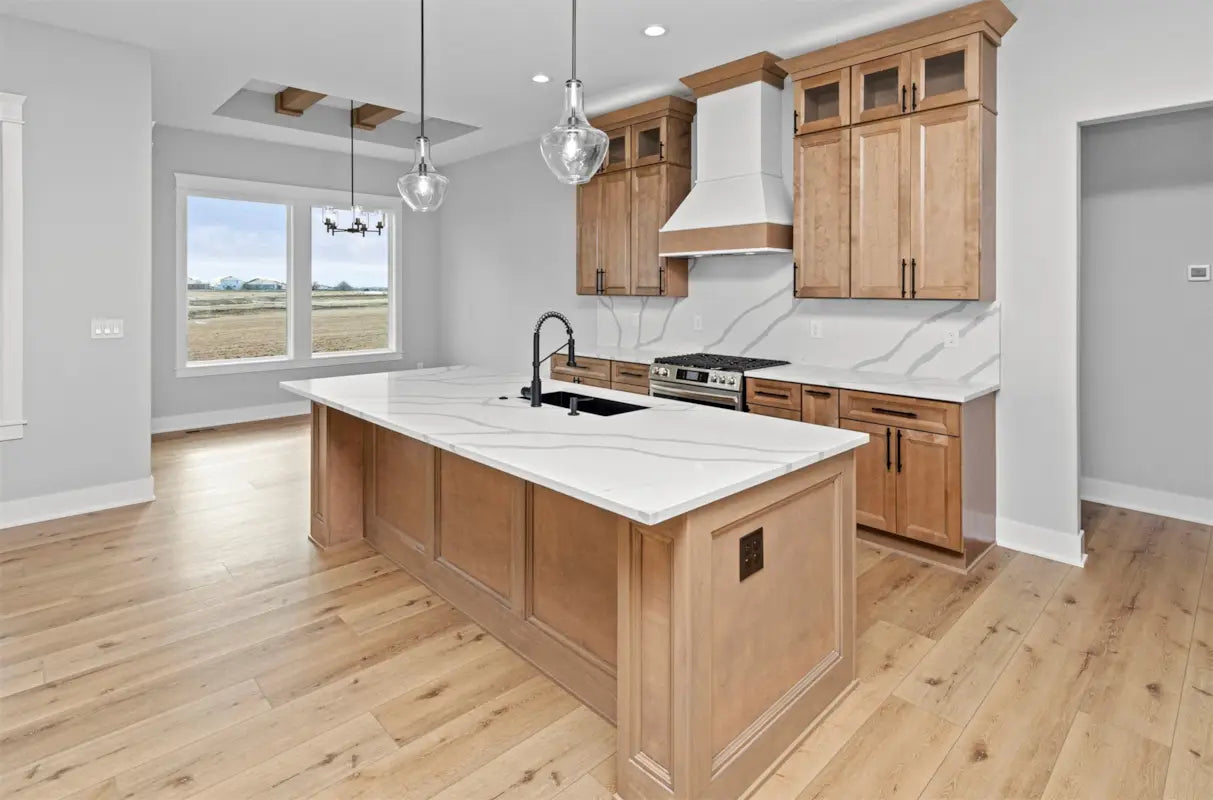 Modern kitchen with wooden cabinets, island, and stainless steel appliances.