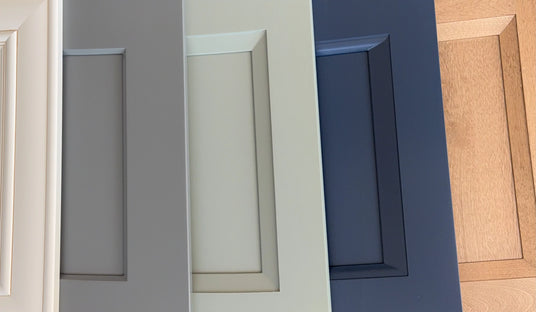 Close-up of different cabinet door sample styles including gray, white, blue, and wood.
